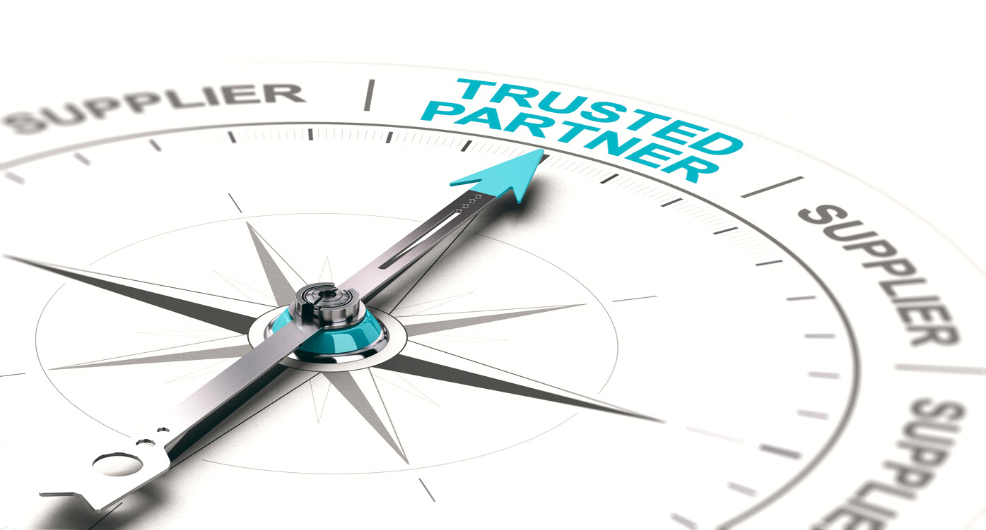a compass with an arrow pointing towards the words "trusted partner"